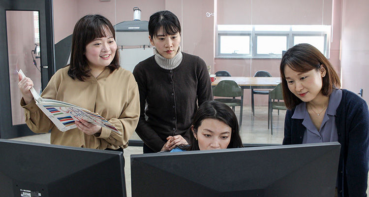 three ladies preparing a report